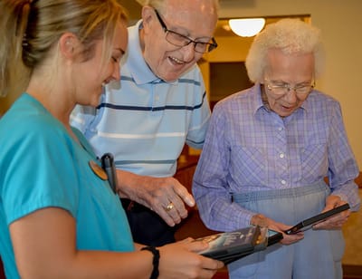 Staff assisting residents with activities in a common area