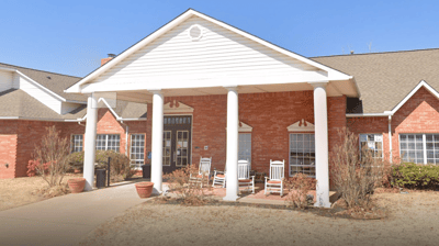 Exterior view of Milestone Senior Living with rocking chairs