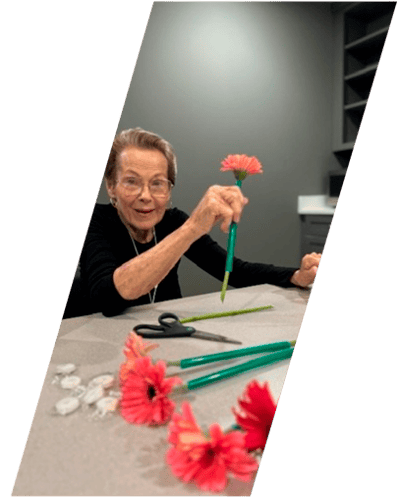 Resident arranging flowers in an activity room