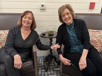 Two residents enjoying each other's company in a lounge area