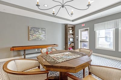 Common area with a puzzle on the table and seating