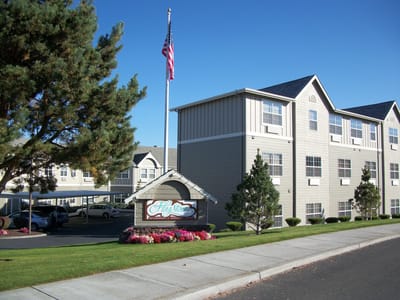 Front exterior of a senior living facility with landscaped grounds