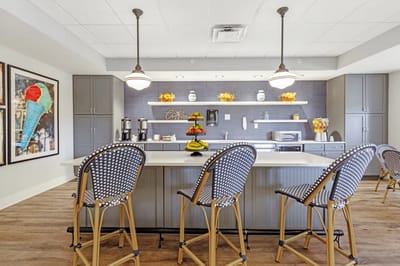 Bright, modern common area with bar seating and decor