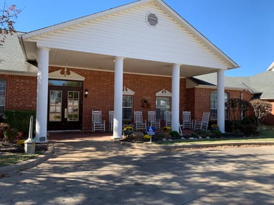 Front entrance of Milestone Senior Living with rocking chairs