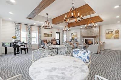 Bright common area with seating and a fireplace