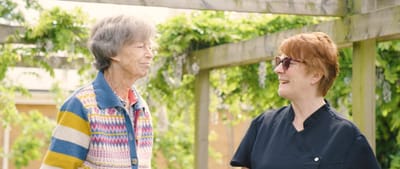 Resident and staff member enjoying time outdoors