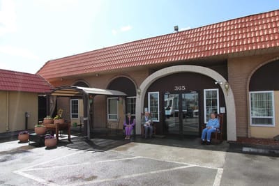 Residents enjoying time outside the facility entrance