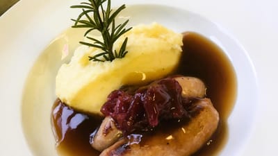 Plate of sausages, mashed potatoes, and gravy
