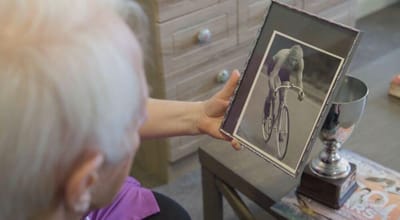 Resident looking at an old cycling photo