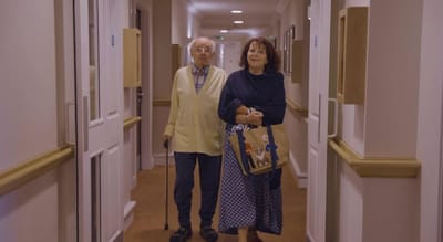 Residents walking in a corridor of the care home