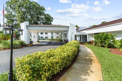 Exterior view of the facility entrance and garden path.