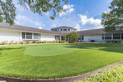 Exterior view of the facility with a putting green