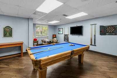 Interior activity room with a pool table and seating
