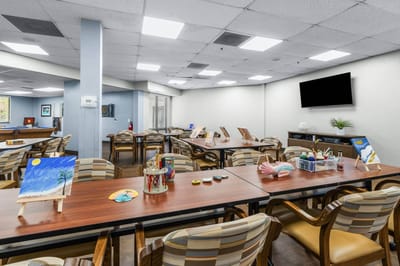 Interior activity room with art supplies and tables