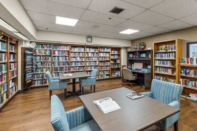 Cozy library space with bookshelves and tables