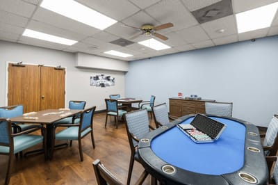 Interior activity room with poker tables and chairs