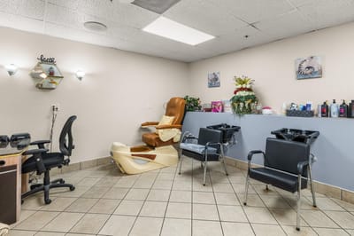 Interior view of a salon area with seating and equipment