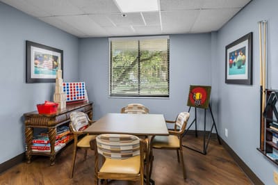 Bright activity room with a table and art.