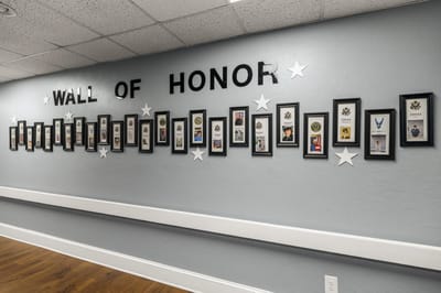 Interior wall displaying a 'Wall of Honor' with framed photos
