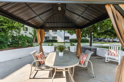 Outdoor seating area with a gazebo and table