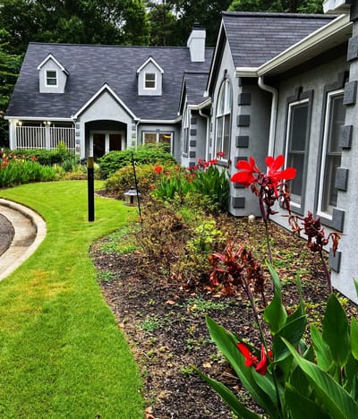 Exterior view of Oak Leaf Manor with garden and flowers