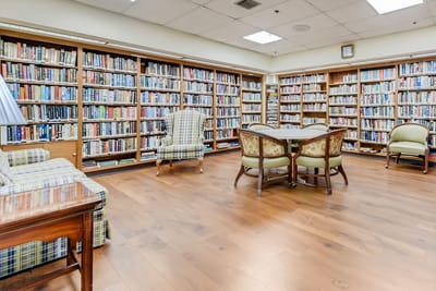 A cozy library with bookshelves and seating