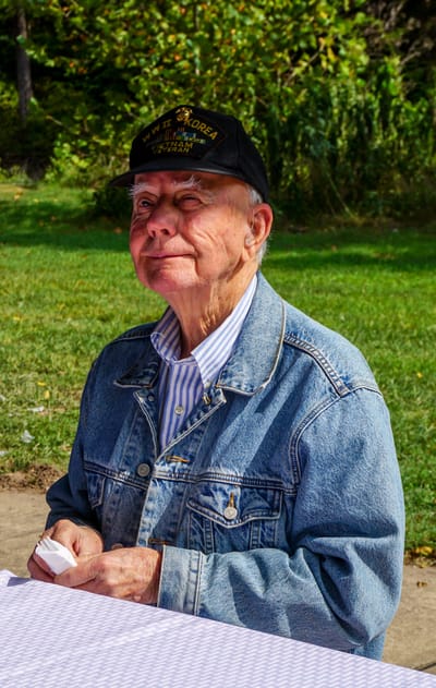 Elderly man sitting outdoors in a park