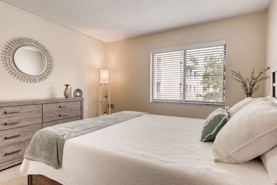 Cozy interior of a private resident room with a bed and dresser