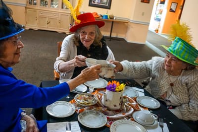 Residents enjoying tea with festive hats during an activity