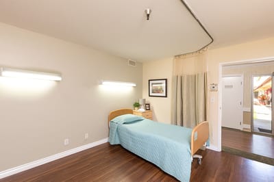 Private resident room with bed and bedside table