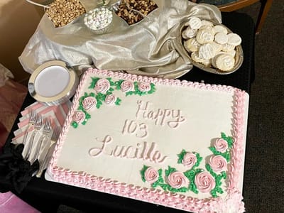 A decorated cake celebrating a 103rd birthday
