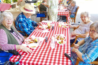 Residents enjoying a meal at a checkered table