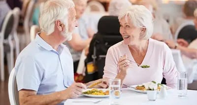 Residents enjoying a meal together in the dining room