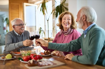 Residents enjoying a meal together with wine
