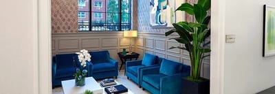 Bright lounge area with blue sofas and natural light