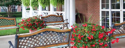 Outdoor seating area with flowers in front of a building