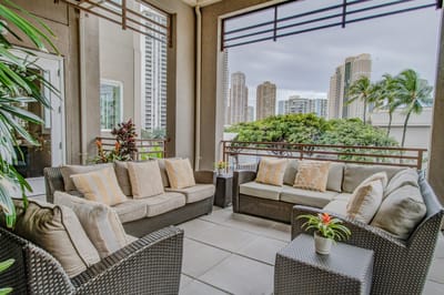 Outdoor lounge area with comfortable seating and city view