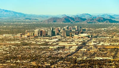 Aerial view of a city skyline with mountains