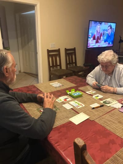 Residents engaging in a card game indoors.