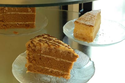 Dessert slices displayed on glass plates.