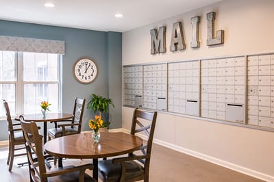 Common area with mailboxes and tables.