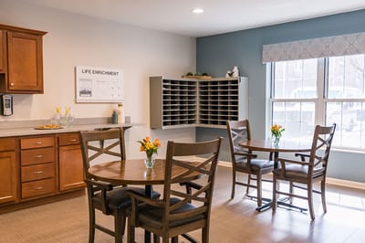 Common area with tables and flower arrangements.