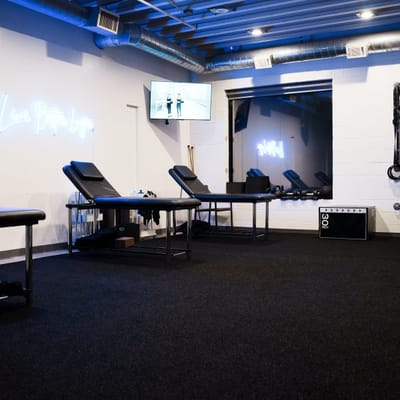 Physical therapy room with treatment tables and equipment.