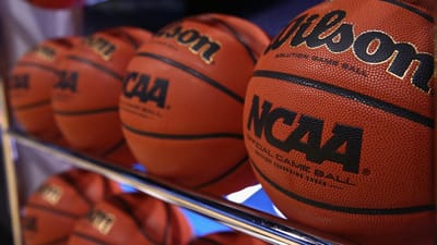 Close-up of basketballs on a rack.