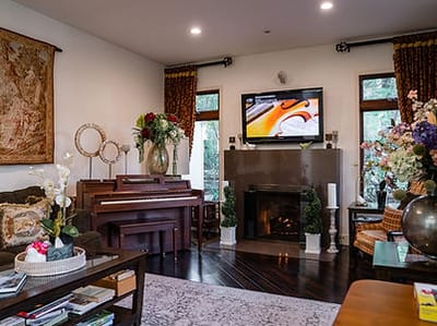 Cozy interior common area with piano and flowers.