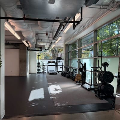 Interior view of a gym area with workout equipment.