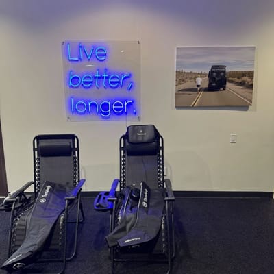 Interior space with neon sign and relaxation chairs.