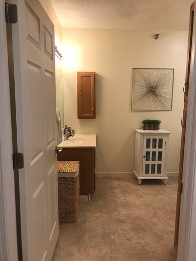 Well-lit bathroom with fixtures and decor