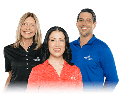 Three staff members in front of a dark background