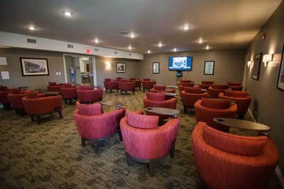 Cozy common area with red chairs and a TV
